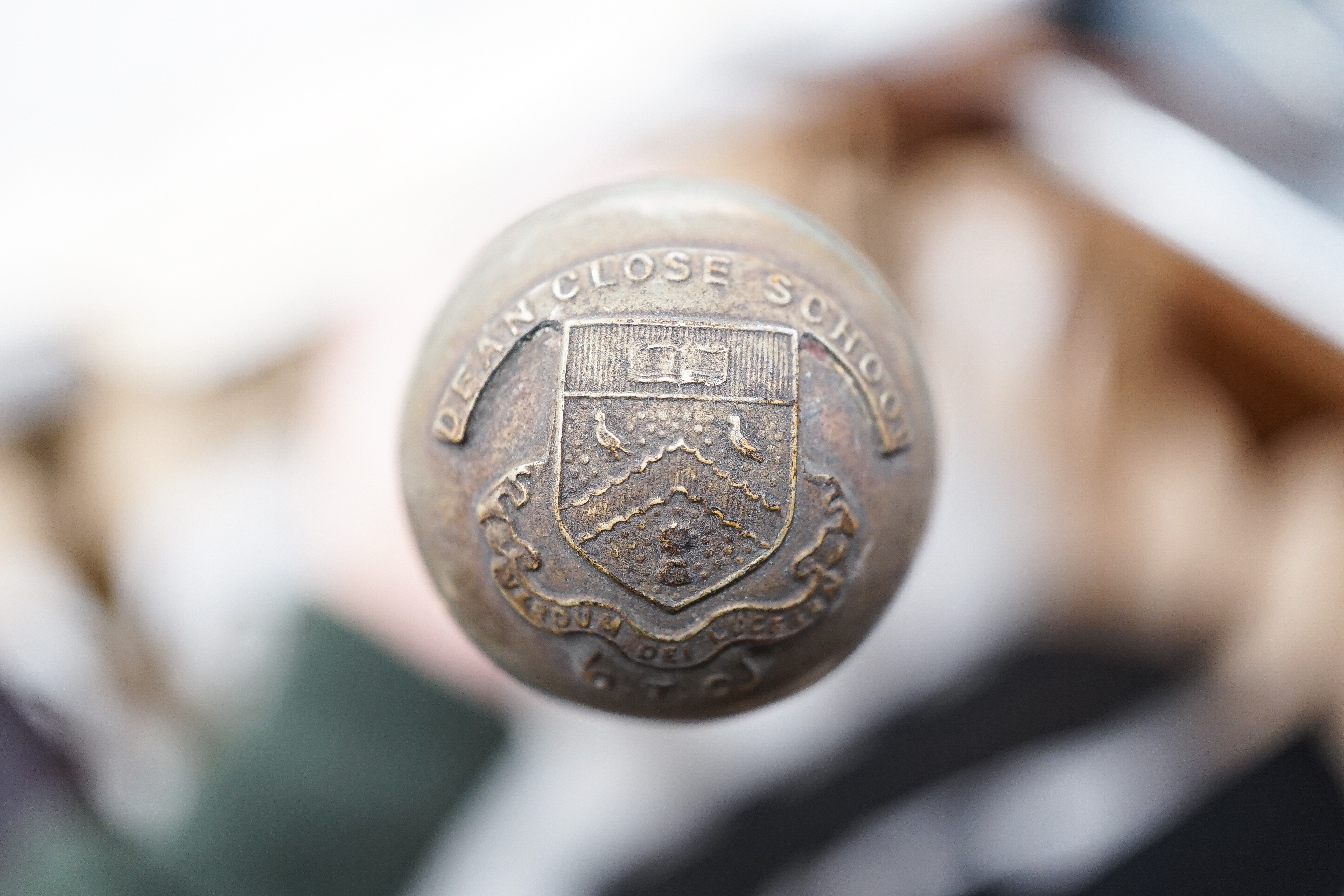 A group of WWI and WWII militaria badges, buttons, two swagger sticks, an armband and a World War I German POW inscribed plaster ornament, longest swagger stick 70 cms long.